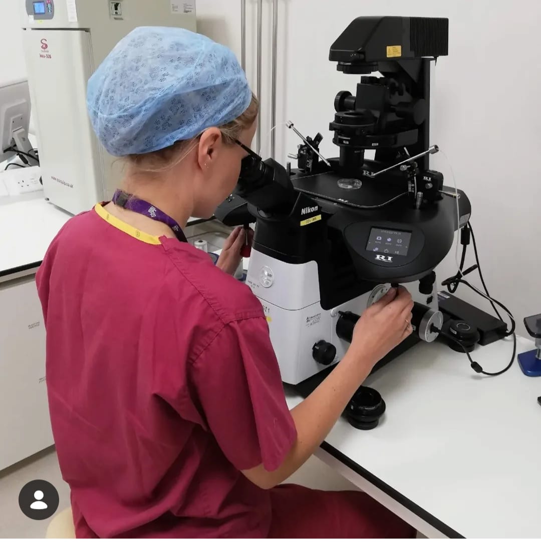 Dr Katie Finch at a micromanipulator workstation in an IVF laboratory.